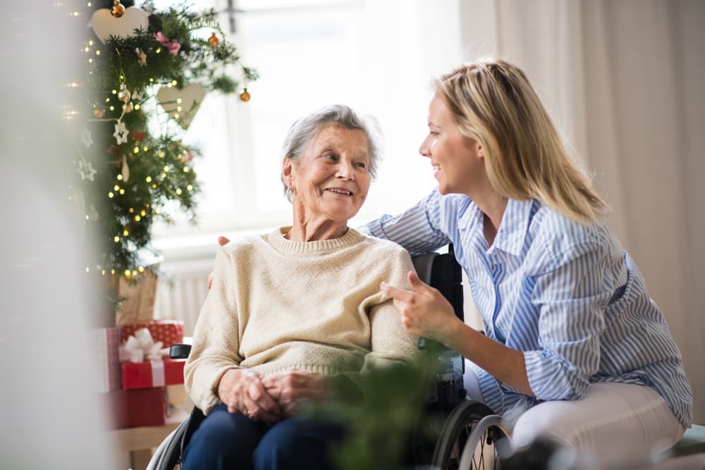 A woman talking to an elderly woman at Christmas